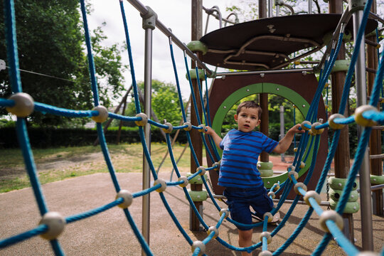 Boy in casual clothes going thorough toy grid