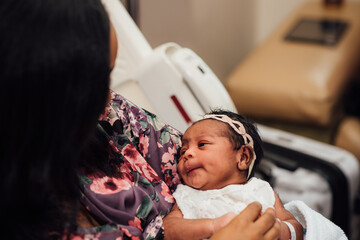 Mom holding newborn at hospital