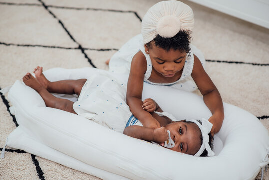 Big sister playing with little sister