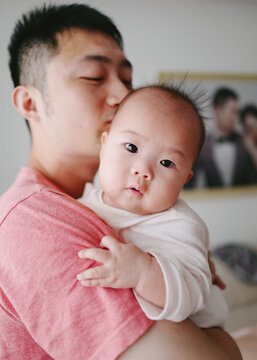 portrait of father with baby at home