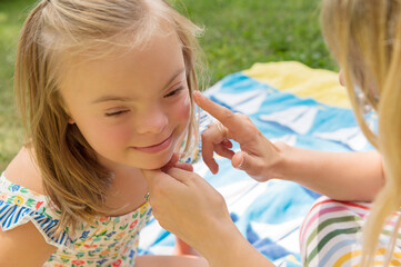 Mother applying sunscreen to daughter's face