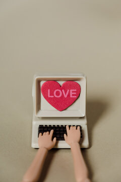 hands doll and computer