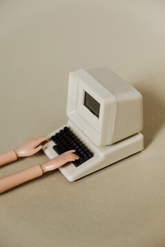 hands doll and computer