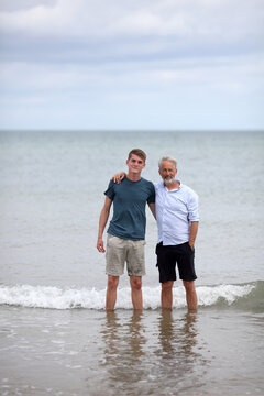 Father and son standing in the sea