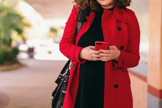 young woman walking with phone