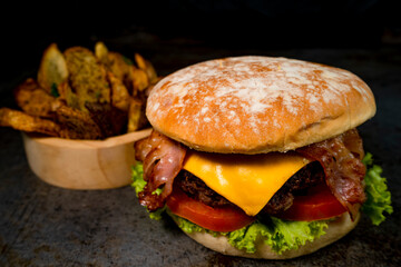 Tasty burger on rustic background