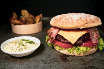 Tasty burger on rustic background
