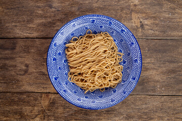 Homemade egg noodles in asian traditional bowl