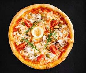 seafood pizza on the black background