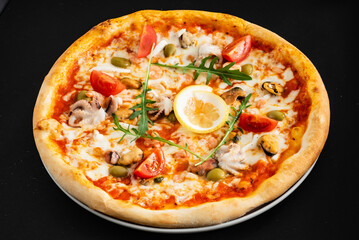 seafood pizza on the black background