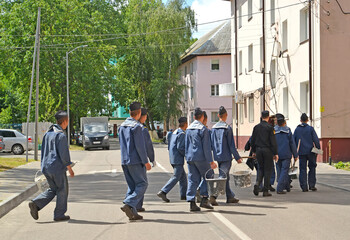 BALTIISK, RUSSIA. A group of sailors in working uniform crosses the street. Kaliningrad region