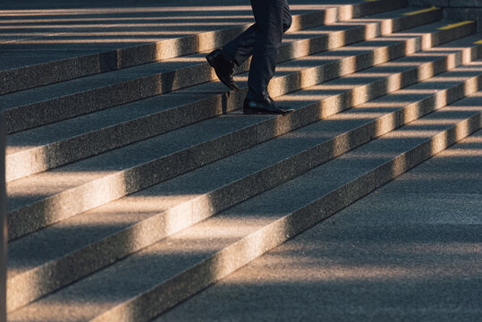 Man walking on gray stone stairs