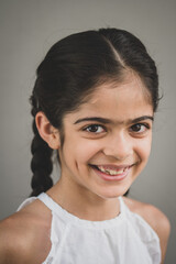 School age girl of British Indian descent displays different facial expressions.