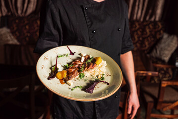 chef with tasty dish in hands