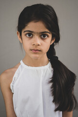 School age girl of British Indian descent displays different facial expressions.