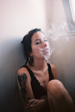 woman exhaling smoke.