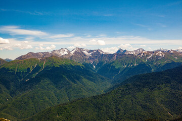 Fototapeta premium Beautiful panoramic view of high snow-capped mountains on a clear sunny day.