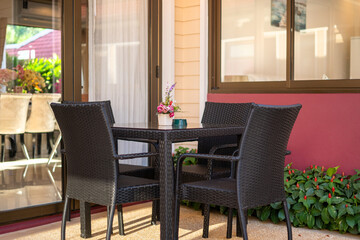 Interior and exterior design of house, home, villa feature outdoor dining table and chairs on balcony outside living room