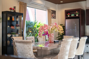 Interior design of house, home, villa, feature dining table, chairs, cabinet, refrigerator with a garden view from kitchen