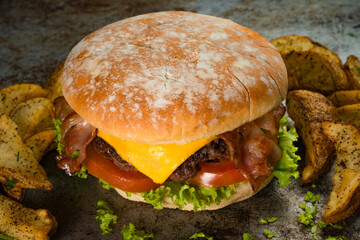 Tasty burger on rustic background