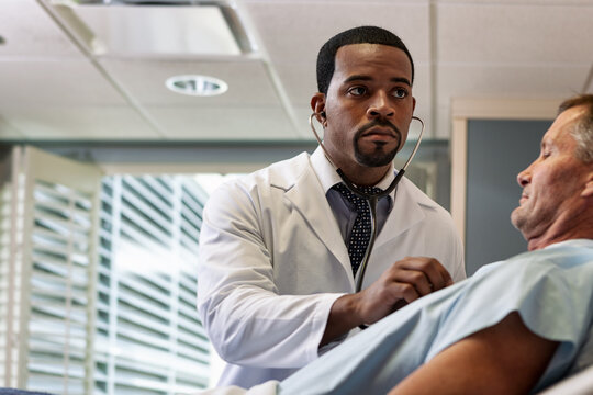 Hospital: Doctor Listens Carefully To Patient's Chest