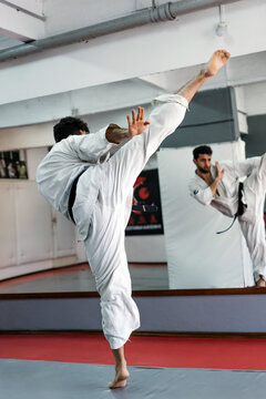 Man Practicing Karate In The Studio.