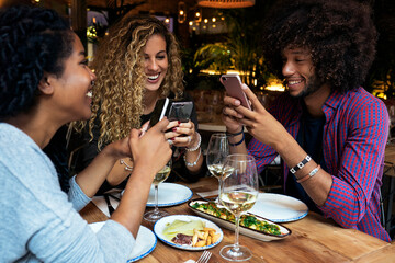 Multiethnic friends group using mobile phone