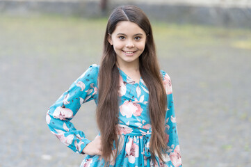Naklejka premium Adorable girl long hair smiling face urban background outdoors, childrens day concept