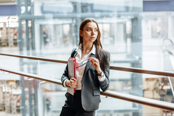 Businesswoman with documents for work. Student girl with folders with documentation. An officer will collect information.