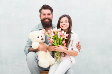 Happy womens day. Happy family celebrate womens day. Bearded man and little child hold flowers and...