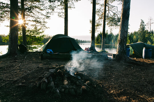 Campsite With Tent and Smoldering Fire