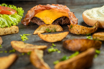 Burger ingredients isolated on rustic background.
