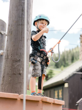 Little boy attempting ropes course