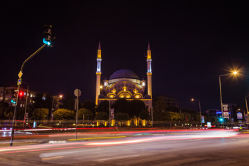Fototapeta na wymiar Fatih Sultan Mehmet mosque night view. Long exposure of traffic lights and mosque. Popular destination in Nilufer district. Bursa, Turkey.