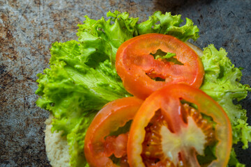 Burger ingredients isolated on rustic background.