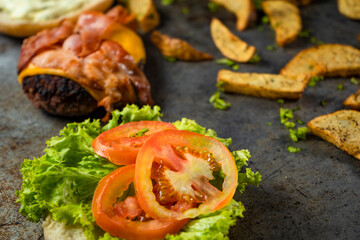 Burger ingredients isolated on rustic background.