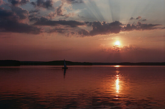 Yacht sailing on sunset