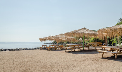 Reed umbrellas on the beach of the island of Lihada-Greece 