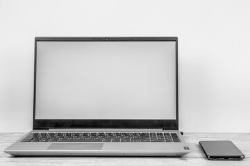 Laptop computer with a white screen on the desktop, blue background. Business and finance