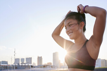 Asian woman preparing for a run.