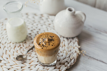 Dalgona whipped coffee, instant, cream, iced coffee. Cocktail with coffee, milk and ice cubes on white background mockup. Trendy drink background with copy space for text.