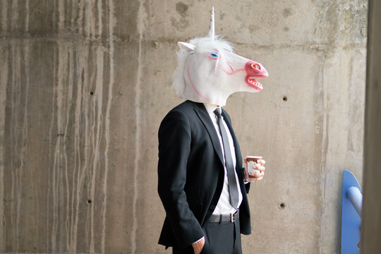 Unicorn in a suit with coffee cup