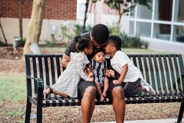 Father kissing kids