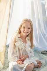 Little girl in white chiffon tent