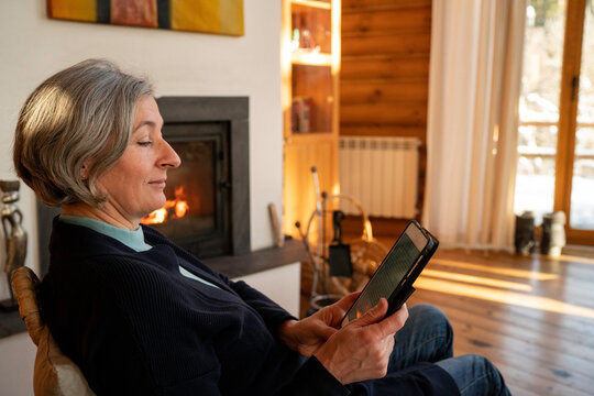 Woman reading book from an electronic tablet