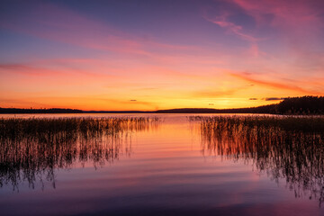 Stunning sunset sky over the calm lake water