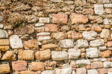 A wall of ordered sea stone on the edge of the beach 