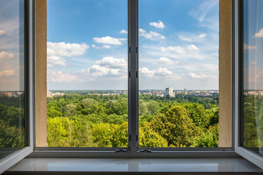 Fototapeta View from the open window at summer cityscape