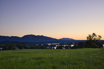 Sunset at lake Staffelsee, Murnau, Germany, with panoramic view, colorful sky and mountain glowing.
