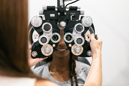 Eyewear: Woman Looks Through Phoropter To Measure Prescription